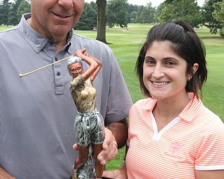 William D. Lewis  The Vindicator Felicia Drevna, winner of women's Long Drive gets triphy from Michael Spiech PGA pro at Tippecano CC.