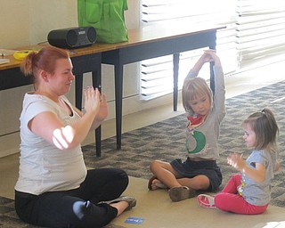 Neighbors | Zack Shively.Mallory Wiand, leader of the Build a Better You! program, taught children a yoga pose at the on Aug. 9.