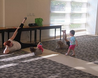 Neighbors | Zack Shively.Children learned about a yoga pose at the Austintown library on Aug 9. The yoga program was a first for many of the children who attended the event.
