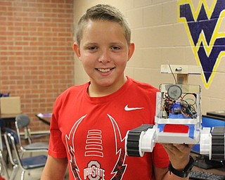 Neighbors | Abby Slanker.Canfield Village Middle School eighth-grader, and second year Robotics Camp attendee, Nolan Williard put the robot he and his team built through a test run to prepare for the robotics competition at the Robotics Camp on Aug. 9.