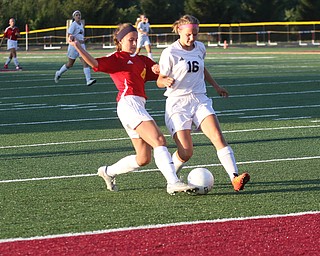     ROBERT K. YOSAY  | THE VINDICATOR..Mooney VS South Range at South Range as Mooney #4 Grace Schaefer  moves the ball past South Range #16Marlaina Slabach  before hitting the net for Mooneys First goal