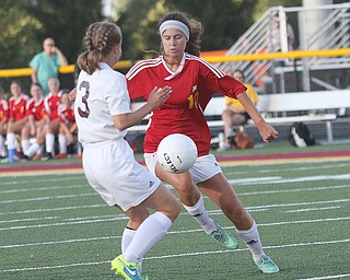    ROBERT K. YOSAY  | THE VINDICATOR..Mooney VS South Range at South Range as Mooney #10 Carolyn Kay drive s the ball around South Range #3Lillian Kimpel during first half action