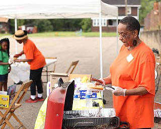Rene Newell of Girard serves up some hotdogs during Rayen Neighborhood Homecoming, Saturday, August 19, 2017 at Rayen Stadium on  in Youngstown's North Side. ..(Nikos Frazier | The Vindicator)