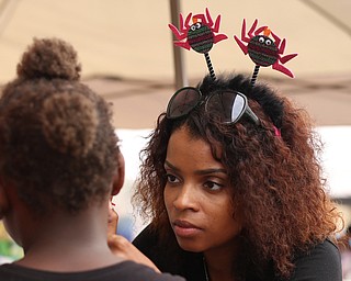 Mykesha Lytle of McDonald paints a butterfly on a young girls face during Rayen Neighborhood Homecoming, Saturday, August 19, 2017 at Rayen Stadium on  in Youngstown's North Side. ..(Nikos Frazier | The Vindicator)