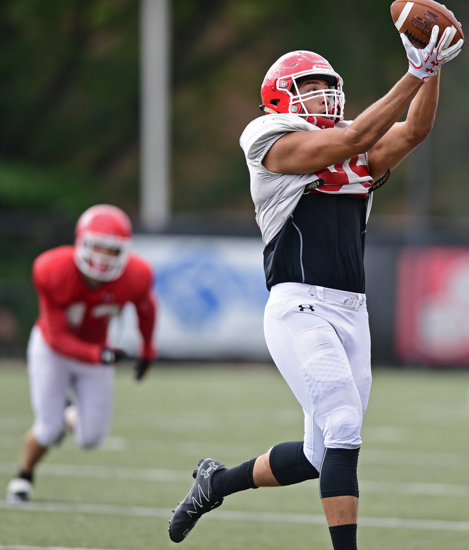 YOUNGSTOWN, OHIO - AUGUST 19, 2017: Youngstown State's Anthony Parente goes up to make a catch during the teams practice Saturday morning at Stambaugh Stadium. DAVID DERMER | THE VINDICATOR