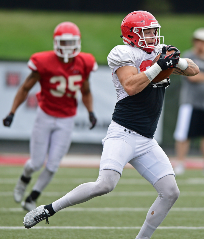 YOUNGSTOWN, OHIO - AUGUST 19, 2017: Youngstown State's Chris Durkin secures the ball while running upfield after a reception during the teams practice Saturday morning at Stambaugh Stadium. DAVID DERMER | THE VINDICATOR