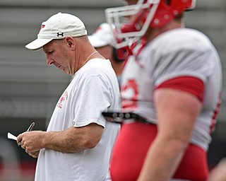 YOUNGSTOWN, OHIO - AUGUST 19, 2017: Youngstown State head coach Bo Pelini looks at his practice script in between plays during the teams practice Saturday morning at Stambaugh Stadium. DAVID DERMER | THE VINDICATOR