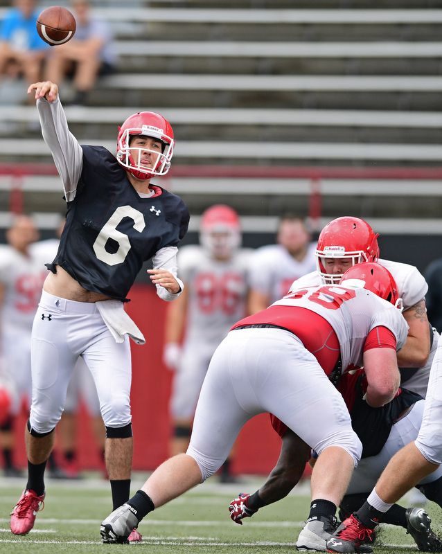 YOUNGSTOWN, OHIO - AUGUST 19, 2017: Youngstown State's Hunter Wells throws a pass behind the block of Connor Sharp, white, during the teams practice Saturday morning at Stambaugh Stadium. DAVID DERMER | THE VINDICATOR