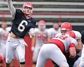 YOUNGSTOWN, OHIO - AUGUST 19, 2017: Youngstown State's Hunter Wells throws a pass behind the block of Connor Sharp, white, during the teams practice Saturday morning at Stambaugh Stadium. DAVID DERMER | THE VINDICATOR