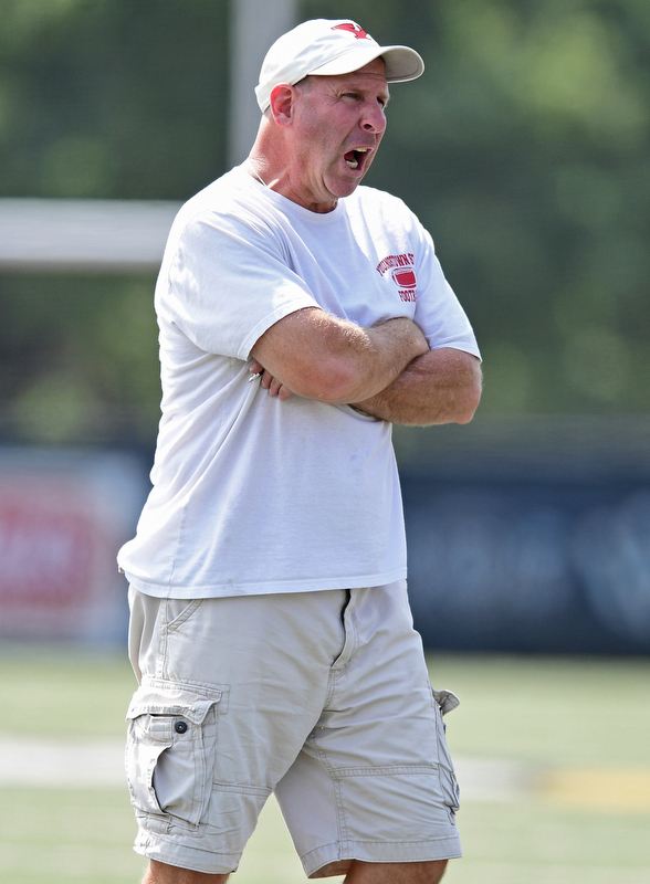 YOUNGSTOWN, OHIO - AUGUST 19, 2017: Youngstown State head coach Bo Pelini shouts during the teams practice Saturday morning at Stambaugh Stadium. DAVID DERMER | THE VINDICATOR
