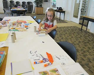 Neighbors | Alexis Bartolomucci.One of the children used cardboard to make a creation during the Engineering Extravaganza at the Austintown library on July 20.