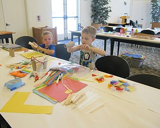 Neighbors | Alexis Bartolomucci.Children made creations out of cardboard, glue and other objects at the Engineering Extravaganza program on July 20 at the Austintown library.