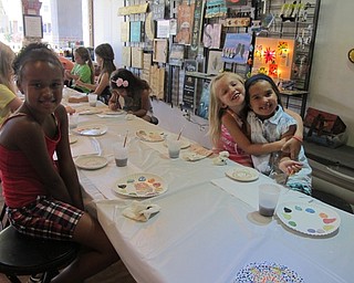 Neighbors | Alexis Bartolomucci.Children painted ceramic plates, making a spotted turtle for one of their art camp projects at Wonderstruck Market.