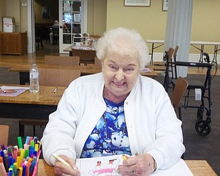 Neighbors | Submitted.Lois Moorhead is pictured trying out one of the adult coloring books at the Poland library. Adult coloring is a growing trend for relaxation.