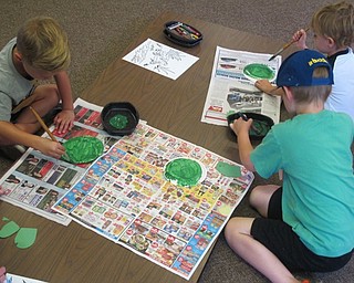 Neighbors | Zack Shively.Children paint plates to look like turtle shells at the Ford Nature Center as a part of the Children's Nature Hour on Aug. 10 at the Ford Nature Center.