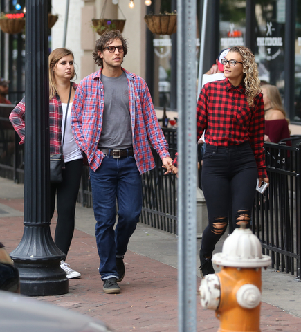 David Itaniano(center) of Youngstown, holds hands with fiance, Yiota Mallias of Youngstown(right) and sister, Katerina Mallias before the Zac Brown Band performs at Stambaugh Stadium, Thursday, August 24, 2017 in downtown Youngstown...(Nikos Frazier | The Vindicator)
