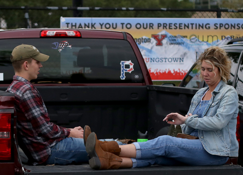 Kelly Adamczyk of New Castle(right) checks her watch while talking with son, Zach, while tailgating before the Zac Brown Band performs at Stambaugh Stadium, Thursday, August 24, 2017 at M70 parking lots at YSU in Youngstown...(Nikos Frazier | The Vindicator)