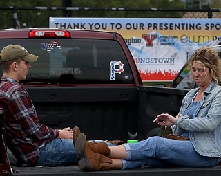 Kelly Adamczyk of New Castle(right) checks her watch while talking with son, Zach, while tailgating before the Zac Brown Band performs at Stambaugh Stadium, Thursday, August 24, 2017 at M70 parking lots at YSU in Youngstown...(Nikos Frazier | The Vindicator)
