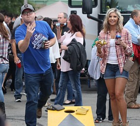 Jenn Bernard(right) and Erik Matyas both of Austintown play cornhole while tailgating before the Zac Brown Band performs at Stambaugh Stadium, Thursday, August 24, 2017 at M70 parking lots at YSU in Youngstown...(Nikos Frazier | The Vindicator)