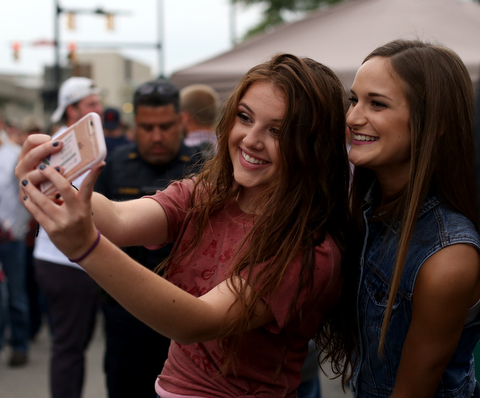 Grace Schaefer(left) and Rachel Kurcon both of Poland take a selfie while tailgating before the Zac Brown Band performs at Stambaugh Stadium, Thursday, August 24, 2017 at M70 parking lots at YSU in Youngstown...(Nikos Frazier | The Vindicator)