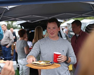 Mike Schafer of Boardman serves some BBQ Chicken Pizza while tailgating before the Zac Brown Band performs at Stambaugh Stadium, Thursday, August 24, 2017 at M70 parking lots at YSU in Youngstown...(Nikos Frazier | The Vindicator)