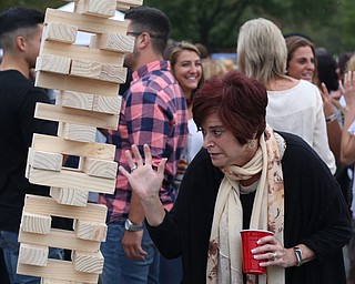 Cindy Clemente of Poland reacts after knocking over a giant Jenga tower while tailgating before the Zac Brown Band performs at Stambaugh Stadium, Thursday, August 24, 2017 at M70 parking lots at YSU in Youngstown...(Nikos Frazier | The Vindicator)