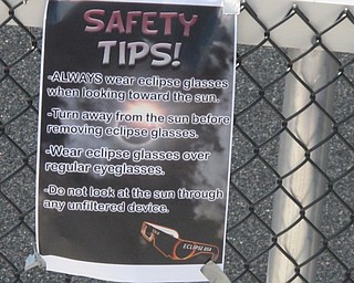 Neighbors | Zack Shively  .Staff at Boardman High School placed safety fliers for the solar eclipse on Aug. 21 on different sections of the stands. They also handed out safety tips on a small piece of paper