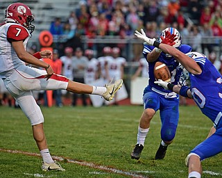 BERLIN CENTER, OHIO - AUGUST 24, 2017: Columbiana's Jarrett Nemick has his punt blocked by Western Reserve's Ryan Slaven and Adam Gatrell during the first half of their game against Columbiana, Thursday night at Western Reserve High School. DAVID DERMER | THE VINDICATOR