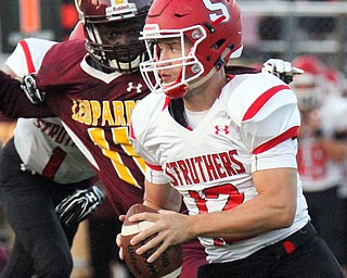William D.Lewis The Vindicator Struthers QB JD Hall(12) eludes Liberty's Ezell Brown(11) during 1rst half action 8-25-17 at Liberty.