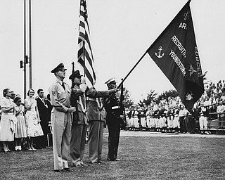 The color guard, representing all branches of the service, presents the colors at the opening of the dedication of Tom Pemberton Park Sunday night as the National Amateur Baseball Federation Tournament got underway here. The team at right is the Dayton Wiedeman-Buds. Youngstown Home Club defeated Dayton, 6-5, in 10 innings in the NABF game at Pemberton Park last night. The park was formerly Shady Run Field.