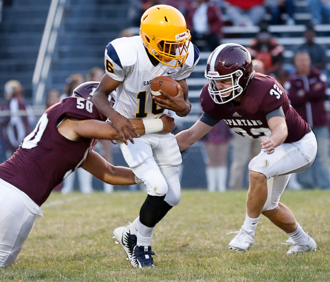 MICHAEL G TAYLOR | THE VINDICATOR-8-25-17 FOOTBALL Youngstown Golden Bears vs Boardman Spartans at Rayen Stadium, Youngstown, OH    2nd qtr., Boardman's #50 Steven Amstutz and #32 Neil Bevacqua sack East's qb #16 Thomas Steele.