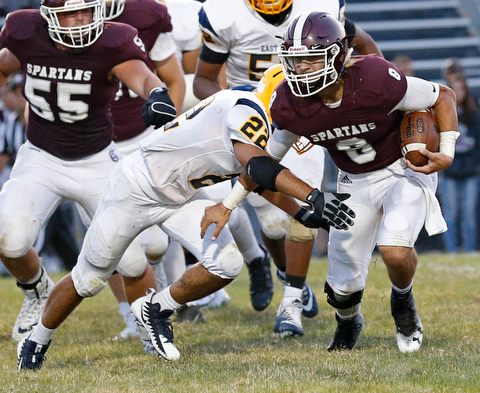 MICHAEL G TAYLOR | THE VINDICATOR-8-25-17 FOOTBALL Youngstown Golden Bears vs Boardman Spartans at Rayen Stadium, Youngstown, OH    2nd qtr.,  Boardman's #8 Michael O'Horo gains the 1st down as East''s #22 Mikese Stevens applies the hit.