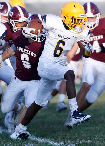 MICHAEL G TAYLOR | THE VINDICATOR-8-25-17 FOOTBALL Youngstown Golden Bears vs Boardman Spartans at Rayen Stadium, Youngstown, OH    1st qtr., East''s #6 Carlos Jones attempts runs for a gain as Boardman's #6 Joe Ieraci tries to bring him down.