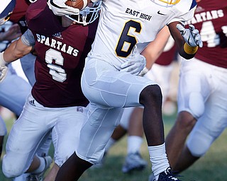 MICHAEL G TAYLOR | THE VINDICATOR-8-25-17 FOOTBALL Youngstown Golden Bears vs Boardman Spartans at Rayen Stadium, Youngstown, OH    1st qtr., East''s #6 Carlos Jones attempts runs for a gain as Boardman's #6 Joe Ieraci tries to bring him down.