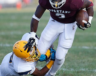 MICHAEL G TAYLOR | THE VINDICATOR-8-25-17 FOOTBALL Youngstown Golden Bears vs Boardman Spartans at Rayen Stadium, Youngstown, OH    1st qtr.,  Boardman's #3 Domonhic Jennings gains the 1st down as East''s #15 Marcus Finkley applies the hit.