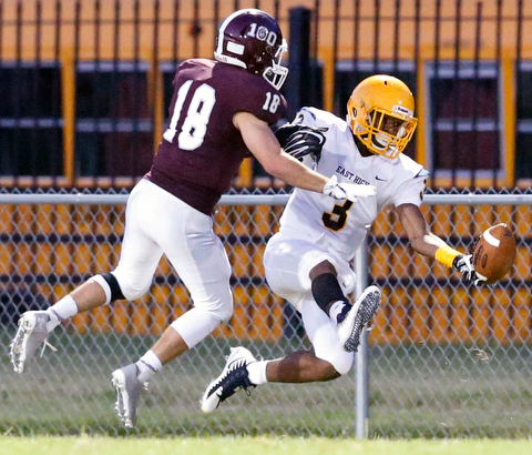 MICHAEL G TAYLOR | THE VINDICATOR-8-25-17 FOOTBALL Youngstown Golden Bears vs Boardman Spartans at Rayen Stadium, Youngstown, OH    2nd qtr., East''s #3 Greg Lincoln attempts to make the catch as Boardman's #18 Dom Stilliana defends.