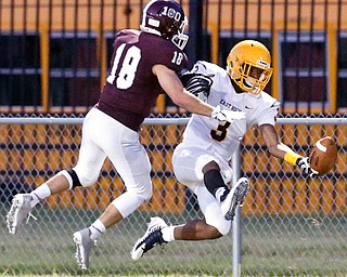 MICHAEL G TAYLOR | THE VINDICATOR-8-25-17 FOOTBALL Youngstown Golden Bears vs Boardman Spartans at Rayen Stadium, Youngstown, OH 2nd qtr., East''s #3 Greg Lincoln attempts to make the catch as Boardman's #18 Dom Stilliana defends.