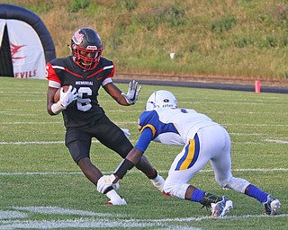 Campbell Memorial's Brandon Liggens (6) stiff arms Valley Chrisitan's Jamynk Jackson(7) during the first quarter of Friday nights matchup at Campbell Memorial High School.  Dustin Livesay  |  The Vindicator  8/25/17  Campbell