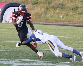 Campbell Memorial's Brandon Liggens (6) stiff arms Valley Chrisitan's Jamynk Jackson(7) during the first quarter of Friday nights matchup at Campbell Memorial High School.  Dustin Livesay  |  The Vindicator  8/25/17  Campbell