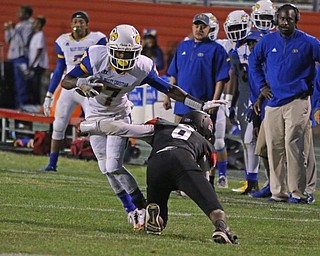 Valley Chrisitan's Jamynk Jackson(7) pushes through a tackle by Campbell's Malachi Bannan (8) during the third quarter of Friday nights matchup at Campbell Memorial High School.  Dustin Livesay  |  The Vindicator  8/25/17  Campbell