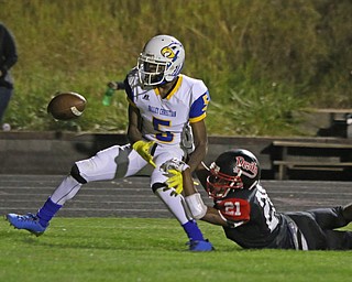 Campbell Memorials Gerald Brown (21) swats the ball away from Valley Chrisitan's Jordan Dukes(5) to prevent a touchdown during the third quarter of Friday nights matchup at Campbell Memorial High School.  Dustin Livesay  |  The Vindicator  8/25/17  Campbell