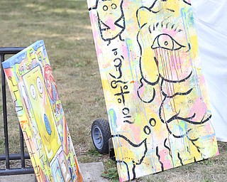 Dog art hangs at varius vendor stalls during the All About Animals Art Show, Saturday, August 26, 2017 at Courthouse Square in Warren...(Nikos Frazier | The Vindicator)