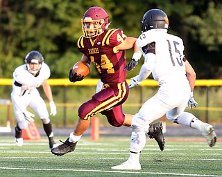 South Range Raiders running back Peyton Remish  (44) breaks through an opening of the defensive line and is confronted by Springfield Local Tiger running back Austin Trebella  (15) during the first quarter as Springfield local takes on South Range, Saturday, August 26, 2017, at Raider's stadium at the Rominger Sports Complex in Canfield...(Nikos Frazier | The Vindicator)..