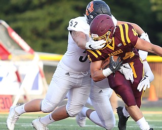 Springfield Local Tiger outside lineman Anthony Stouffer  (52) grabs South Range Raiders running back Peyton Remish  (44)'s face mask during the first quarter as Springfield local takes on South Range, Saturday, August 26, 2017, at Raider's stadium at the Rominger Sports Complex in Canfield...(Nikos Frazier | The Vindicator)..