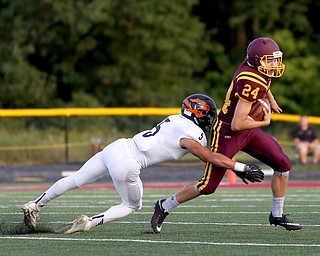 Springfield Local Tiger running back Ryan Ohlin  (5) tackles South Range Raiders kicker Brandon Youngs  (24) during the first quarter as Springfield local takes on South Range, Saturday, August 26, 2017, at Raider's stadium at the Rominger Sports Complex in Canfield...(Nikos Frazier | The Vindicator)..