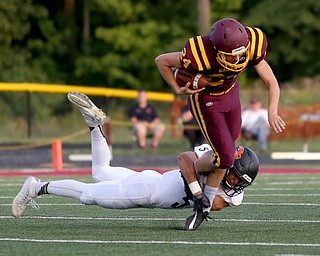 Springfield Local Tiger running back Ryan Ohlin  (5) tackles South Range Raiders kicker Brandon Youngs  (24) during the first quarter as Springfield local takes on South Range, Saturday, August 26, 2017, at Raider's stadium at the Rominger Sports Complex in Canfield...(Nikos Frazier | The Vindicator)..