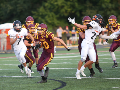 South Range Raiders wide receiver Mathias Combs  (18) breaks free of the pack to score a touchdown during the first quarter as Springfield local takes on South Range, Saturday, August 26, 2017, at Raider's stadium at the Rominger Sports Complex in Canfield...(Nikos Frazier | The Vindicator)..
