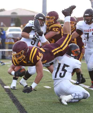 South Range Raiders running back Peyton Remish  (44) flips over Springfield Local Tiger running back Austin Trebella  (15) during the second quarter as Springfield local takes on South Range, Saturday, August 26, 2017, at Raider's stadium at the Rominger Sports Complex in Canfield...(Nikos Frazier | The Vindicator)..