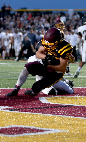 South Range Raiders tight end Josh Stear  (20) catches the pass for a touchdown as he is tackled by Springfield Local Tiger quarterback  Brandon Walters  (3) during the second quarter as Springfield local takes on South Range, Saturday, August 26, 2017, at Raider's stadium at the Rominger Sports Complex in Canfield...(Nikos Frazier | The Vindicator)..