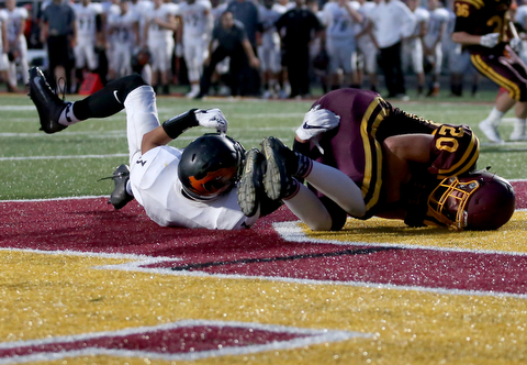 South Range Raiders tight end Josh Stear  (20) catches the pass for a touchdown as he is tackled by Springfield Local Tiger quarterback  Brandon Walters  (3) during the second quarter as Springfield local takes on South Range, Saturday, August 26, 2017, at Raider's stadium at the Rominger Sports Complex in Canfield...(Nikos Frazier | The Vindicator)..